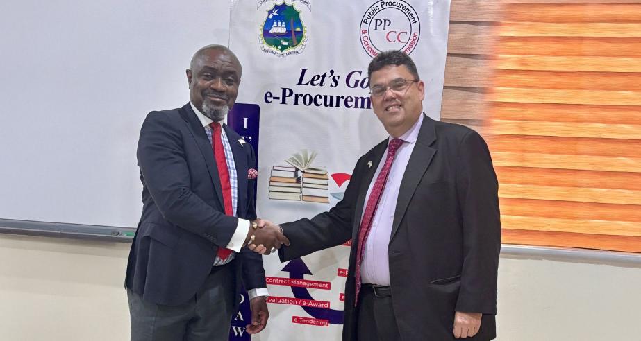PPCC Executive Director, Bodger Scott Johnson, shakes hands with Joseph Zadrozny, the United States Chargé d’Affaires to Liberia.