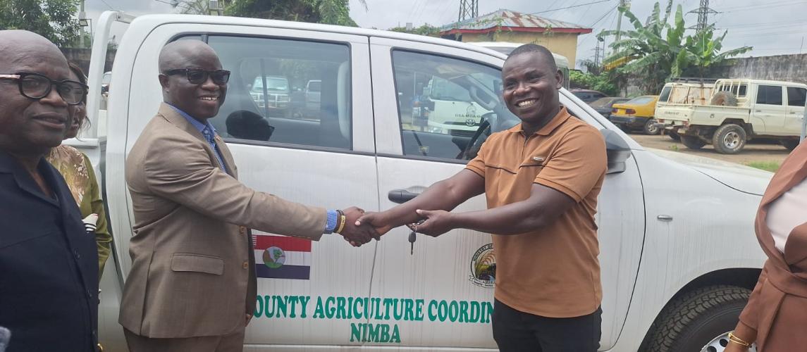 Minister Nuetah handing over the key of one of the vehicles to Nimba CAC